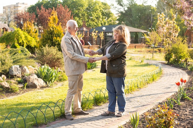 Outdoor portrait of loving senior couple, happy and smiling