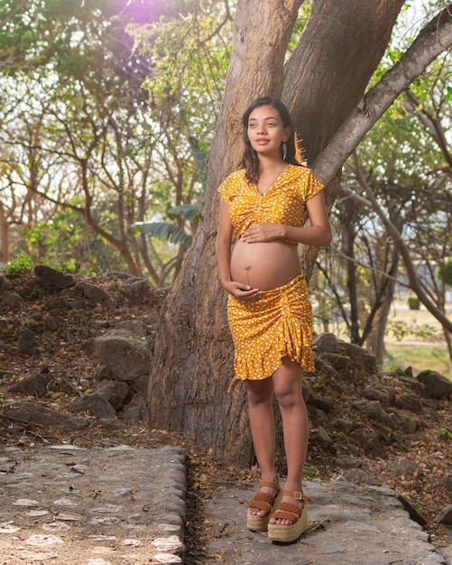 Outdoor portrait of pregnant young woman