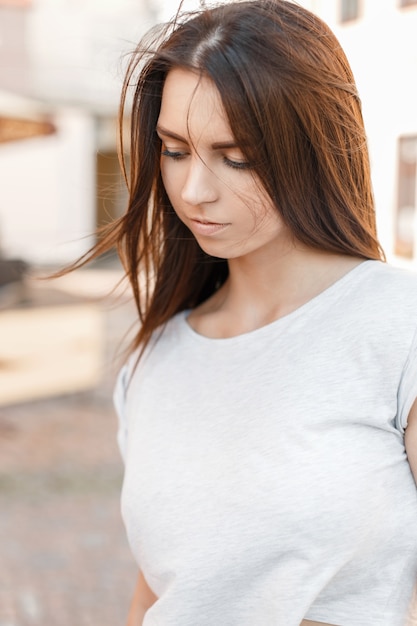 Ritratto all'aperto di una bella donna in una maglietta nella giornata di sole estivo