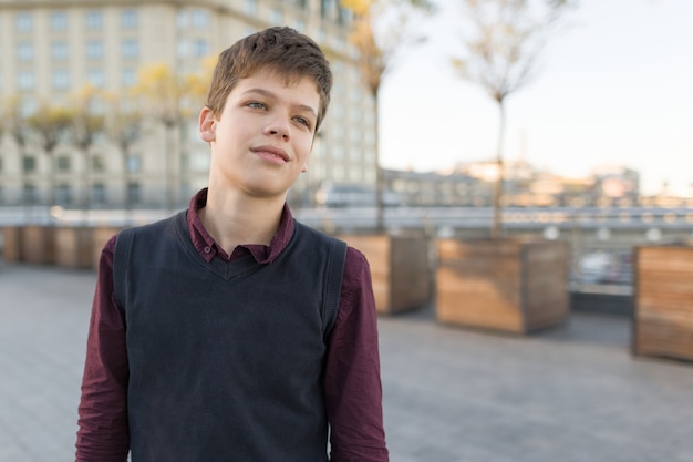 Outdoor portrait of smiling teenager boy