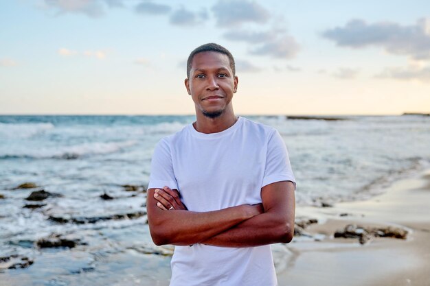 Outdoor portrait of smiling young african american man looking\
in camera