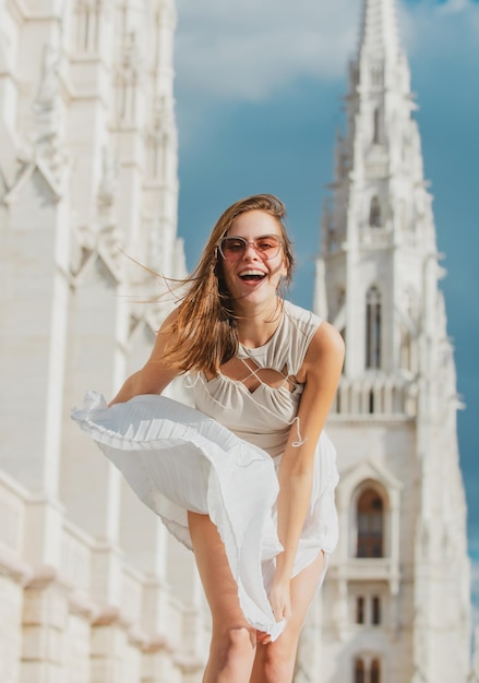 Outdoor portrait of young elegant woman walking in street Young fashion model urban style Movement excited launching amazed woman