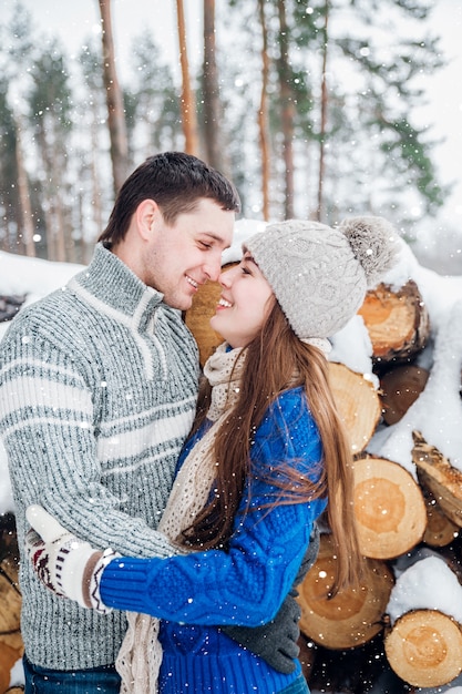 Outdoor portrait of young sensual couple in cold winter wather. love and kiss