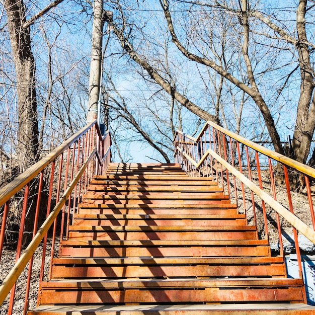 Outdoor rusty metal steps on spring