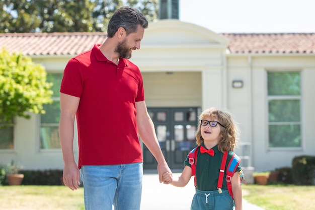 Outdoor school american father and son walking trough school park