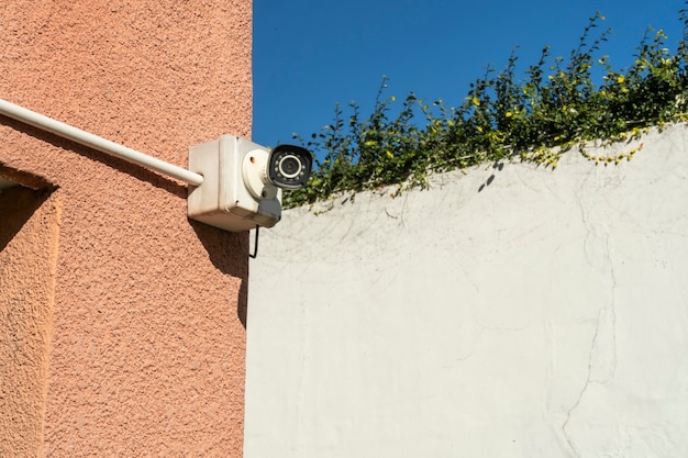 Outdoor security or surveillance camera installed on the exterior wall of a building. Concept security, remote surveillance, surveillance.