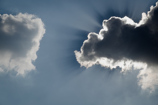 Outdoor shot of blue sky and clouds and sun behind cloud. Cumulus sunset clouds