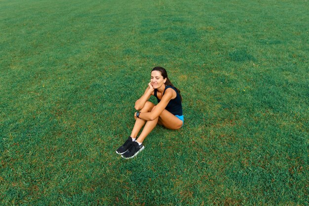 Outdoor shot of young woman athlete running on racetrack. Professional sportswoman during running training session.