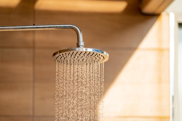 Outdoor shower head for the bath and showering cold water to body before jumping in the resort pool