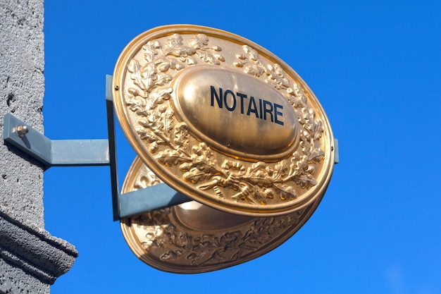 Outdoor sign indicating that a Notaire french for notary is practicing inside the building