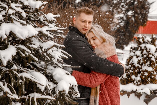 Outdoor waist up portrait of young beautiful happy smiling couple posing on street.