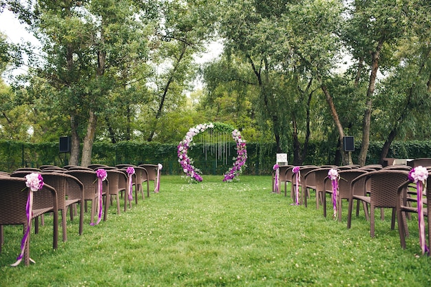 An outdoor wedding ceremony area. decor elements.