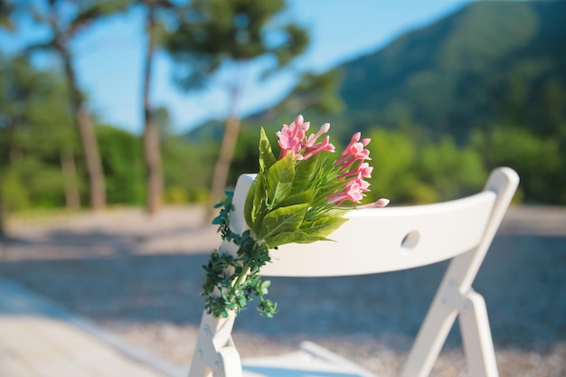 Outdoor wedding chairs emotionally decorated with hanging flowers