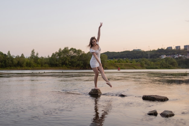 Outdoors fashion photo of beautiful bohemian lady at river