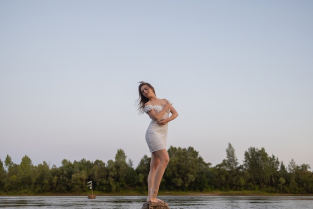 Outdoors fashion photo of beautiful bohemian lady at river