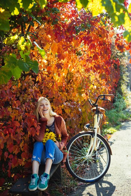 Outdoors lifestyle fashion portrait of pretty young woman walking on the autumn park autumn fashion ...