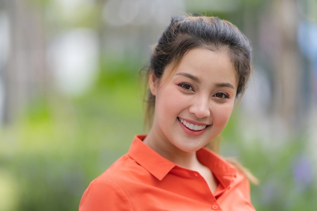 Outdoors portrait of Happy young woman with smiling face