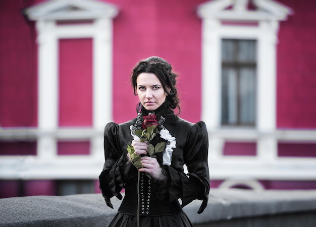 Outdoors portrait of a lady with the red rose