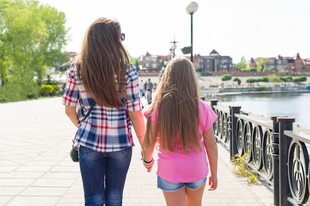 Outdoors portrait of mother and daughter