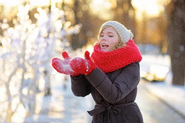 Outdoors portrait of young beautiful woman having fun in winter