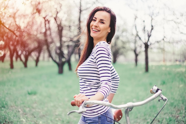 Outdoors relax and riding Woman with bicycle in park