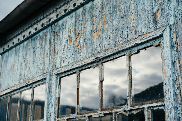 Outdoors shot of small windows of a wooden veranda of an old village house