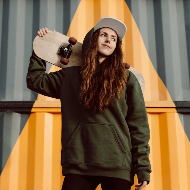 Outdoors skater girl and her skateboard