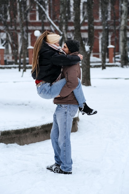 Outdoors winter dates for couples winter love story Cold season dating for couples Young couple in love hugging and kissing in winter city street and park