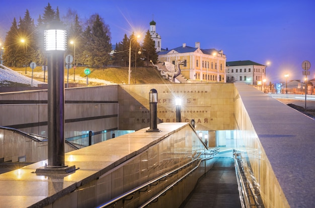 The outer lobby of the Kremlin metro in Kazan and the temple of the John the Baptist Monastery in the light of night lights. Caption: Kremlin Metro. Kremlin Station