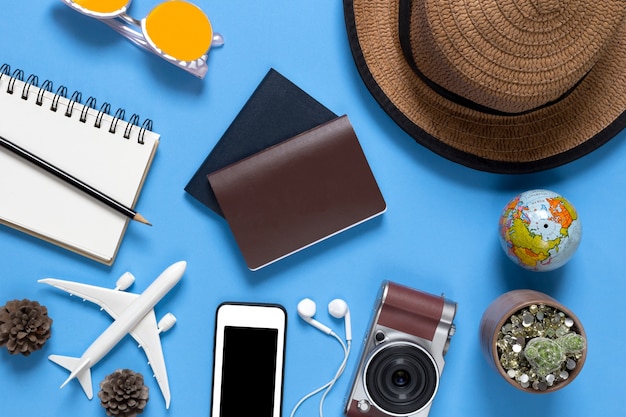 Outfit and accessories of traveler on blue background with copy space, Travel concept