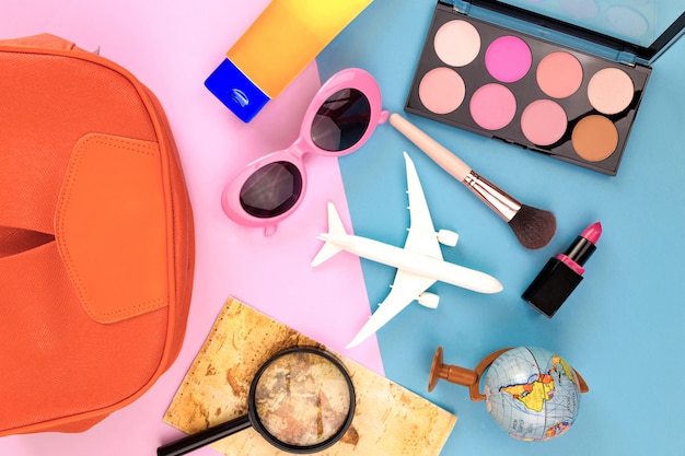  Outfit and accessories of traveler on blue and pink background 