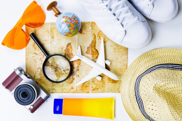 Outfit and accessories of traveler on white background with copy space