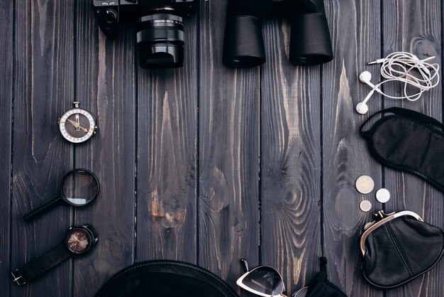 Outfit of traveler on wooden background