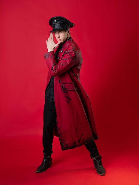 An outrageous young man in a daring red coat in a vintage noir style,