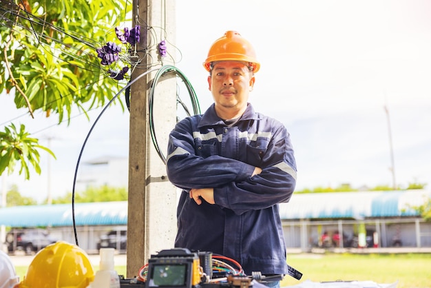 Photo outside an isp internet service provider engineer stands near a fiber optic cross box