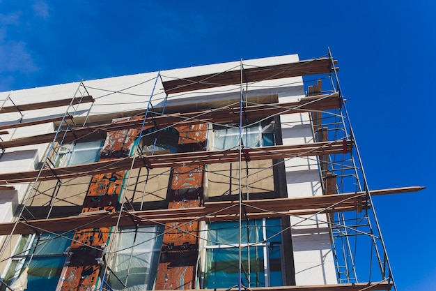 Outside renovation of a modern house scaffolding tower