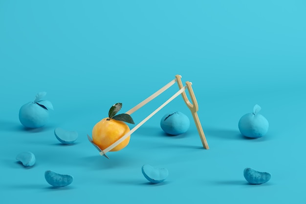 Outstanding mandarin orange in a slingshot surrounded on blue background