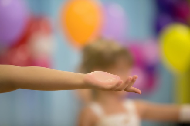 Outstretched hand on a bright blurred background