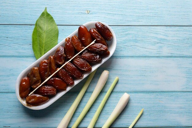 Oval Box of Dates on wooden background