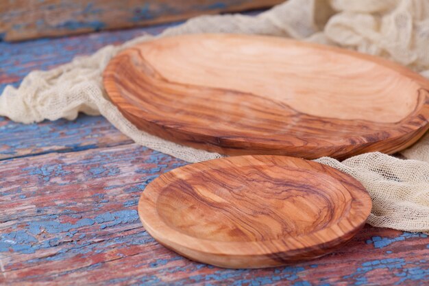 Oval wooden plate on a background of old boards