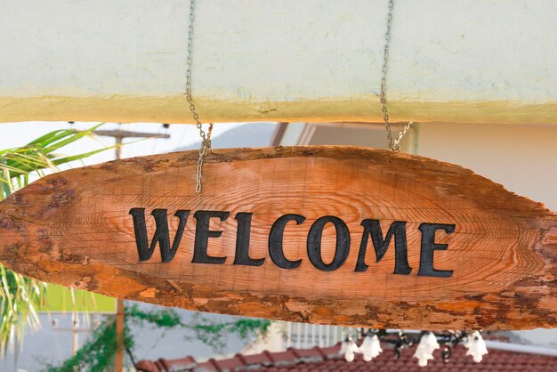 Oval wooden signboard with the inscription welcome