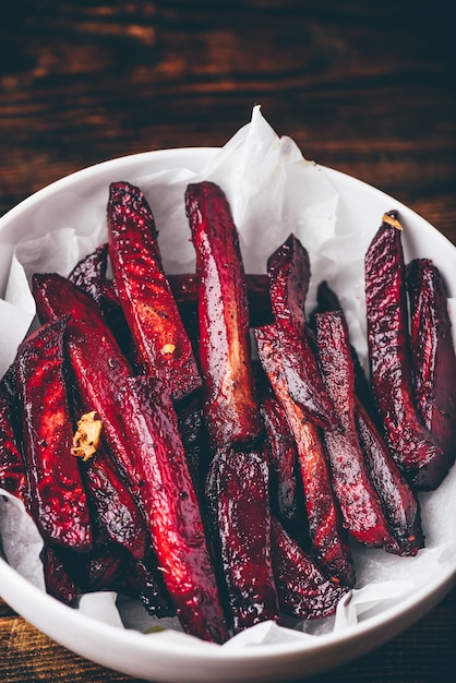 Oven baked beet fries in white bowl