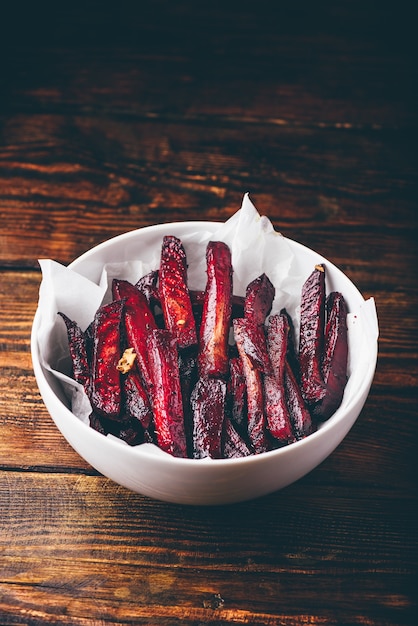 Oven baked beet fries in white bowl