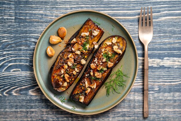 Oven baked eggplant fries with walnuts garlic and herbs in plate top view