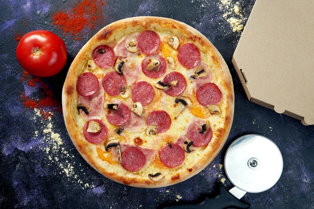 Oven baked italian pizza with melted cheese and salami