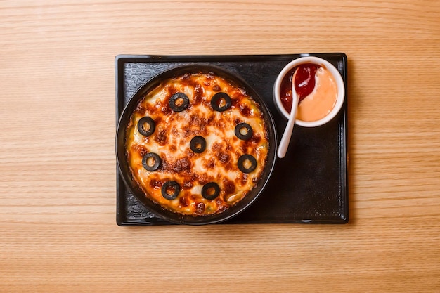 Oven baked Pasta Encantos with dip and tomato sauce served in tray isolated on table top view of fastfood