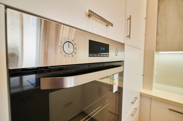 Oven closeup extreme wide angle close up of electric stove with\
open door in modern kitchen