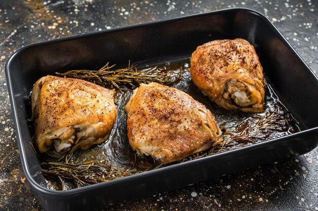 Oven Roasted chicken thighs with spices in baking dish.   Top View.