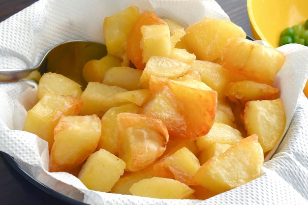 Oven roasted potatoes on kitchen paper towel in a bowl