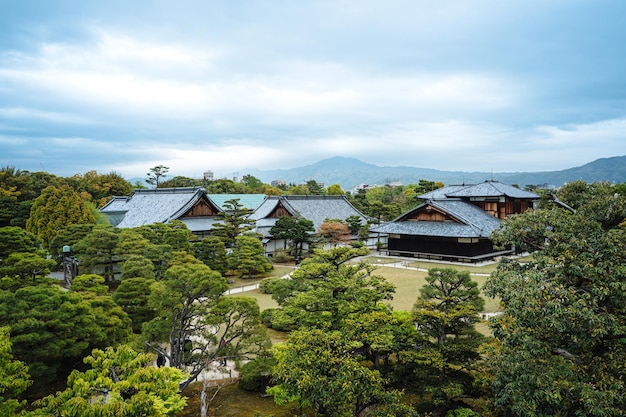 Overall scenic view of the beautiful nijo castle surrounded by\
trees in spring on a clear sunny day. panoramic view of the peace\
and quiet of nijo castle in kyoto, japan.